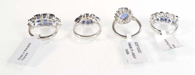 Lot 793 - Four silver dress rings set blue stones,...