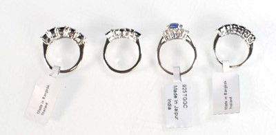 Lot 793 - Four silver dress rings set blue stones,...