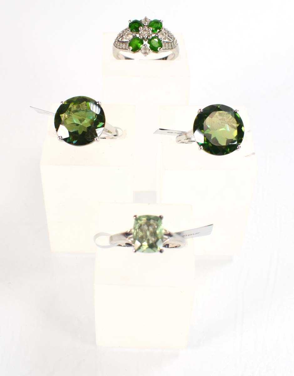 Lot 795 - Four silver dress rings set green stones,...