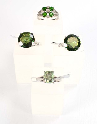 Lot 795 - Four silver dress rings set green stones,...