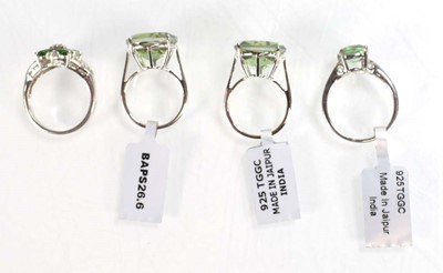 Lot 795 - Four silver dress rings set green stones,...