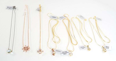 Lot 798 - Seven silver gilt and metalware pendant...