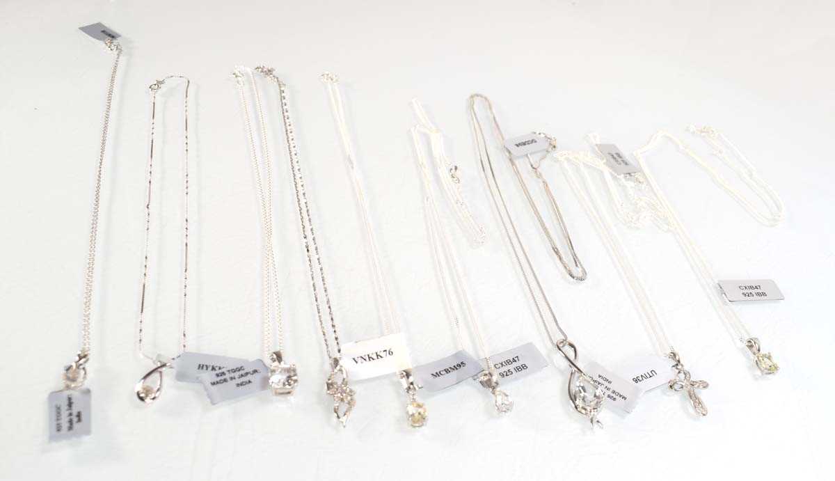 Lot 799 - Nine silver and metalware pendant necklaces...