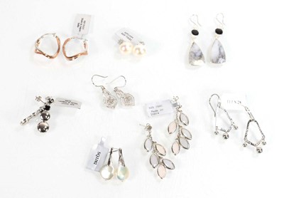 Lot 812 - Eight pairs of silver ear pendants and studs,...