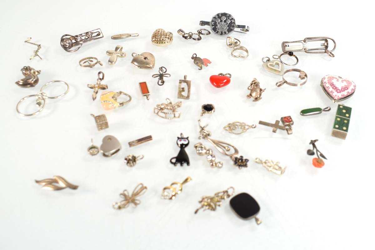 Lot 824 - A collection of silver and metalware pendants,...
