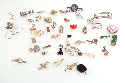 Lot 824 - A collection of silver and metalware pendants,...