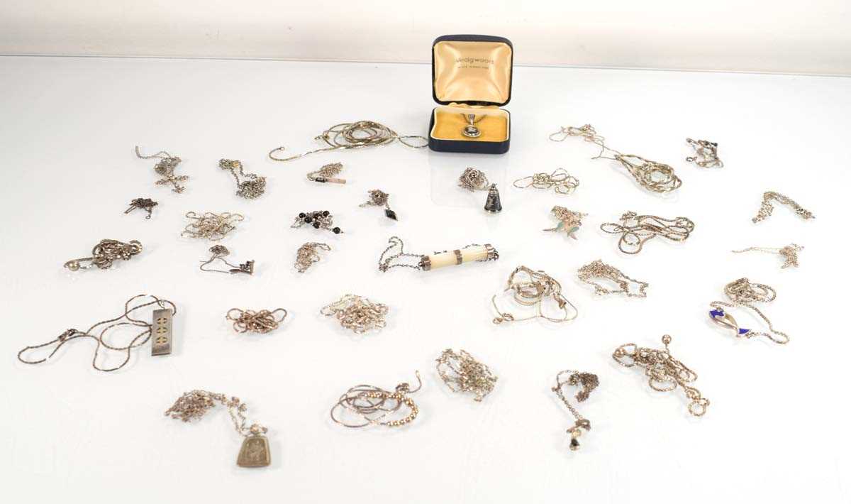 Lot 825 - A collection of silver and metalware pendants,...