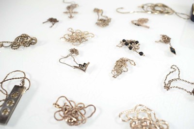 Lot 825 - A collection of silver and metalware pendants,...