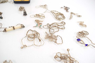 Lot 825 - A collection of silver and metalware pendants,...