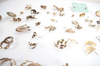 Lot 826 - A collection of silver and metalware ear studs...