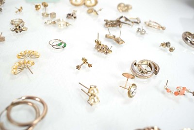Lot 826 - A collection of silver and metalware ear studs...