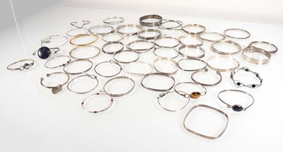 Lot 827 - A collection of silver and metalware bangles...