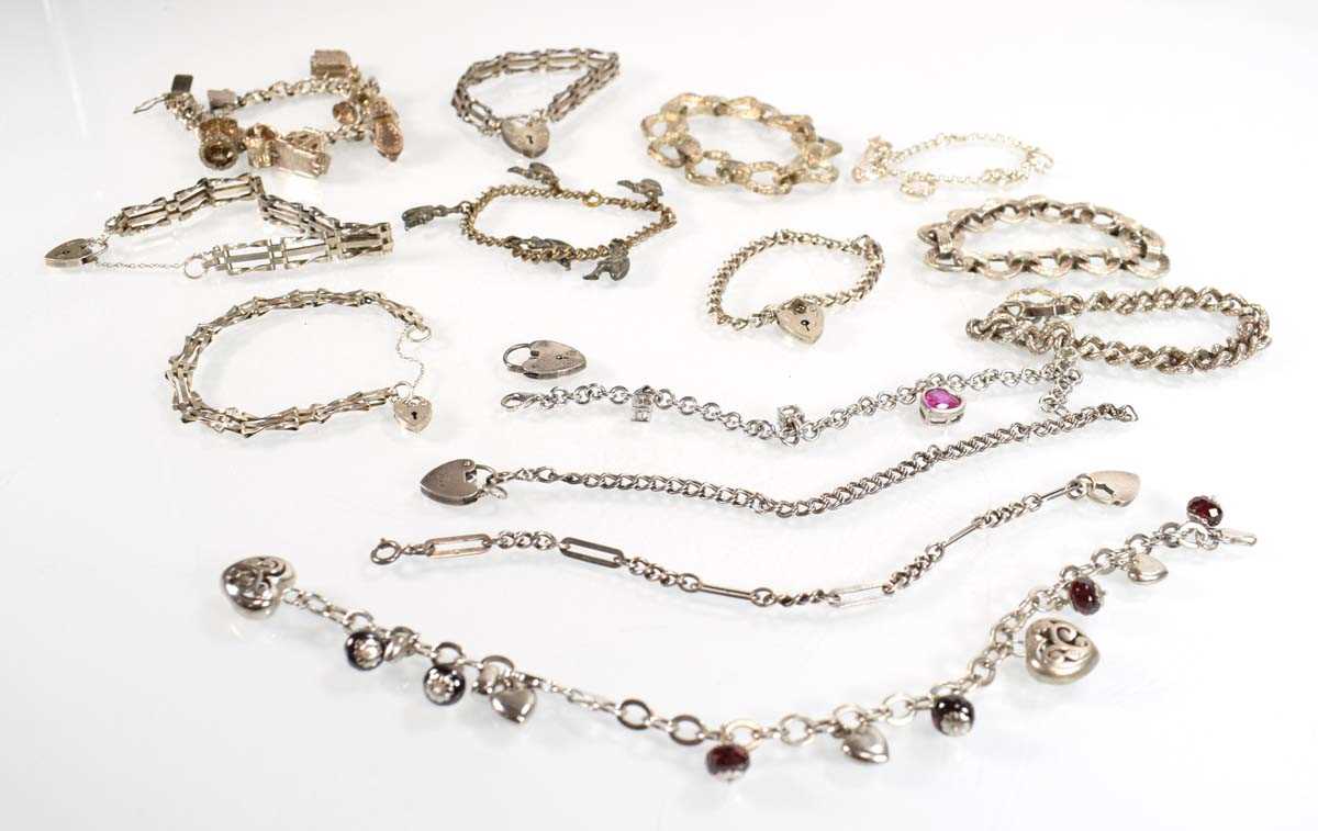 Lot 829 - Fourteen silver and metalware charm and...