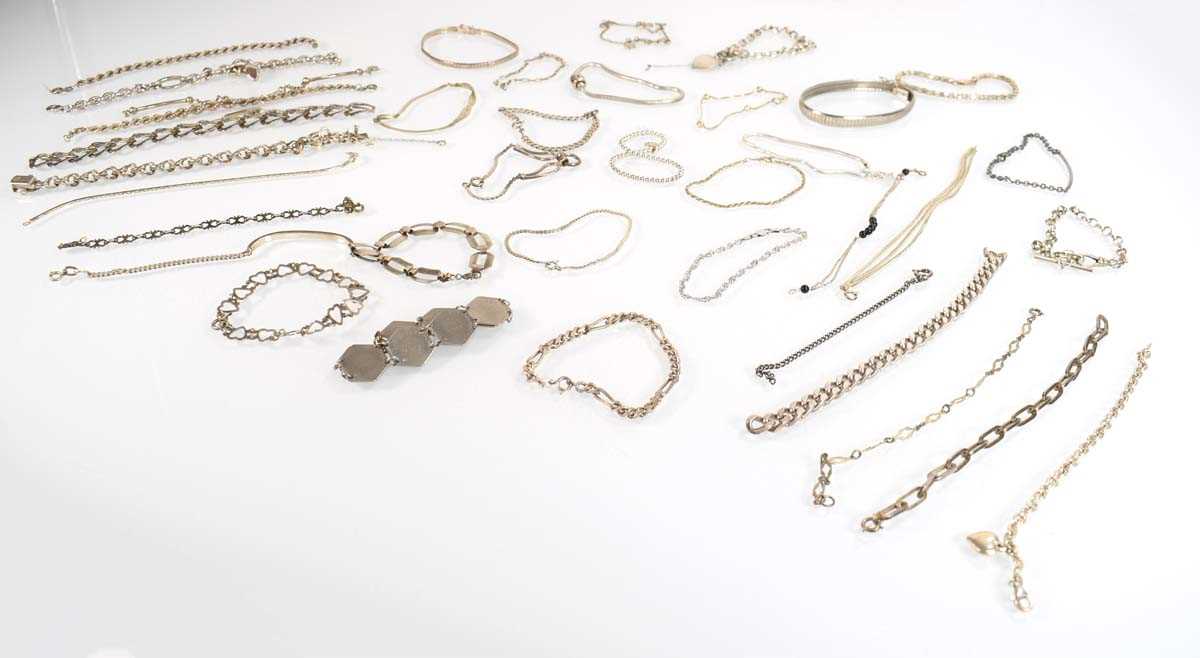 Lot 828 - A collection of silver and metalware bracelets...