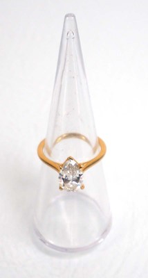 Lot 831 - An 18ct yellow gold ring set pear shaped lab...