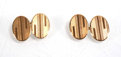 Lot 833 - A pair of 9ct yellow gold oval engine turned...