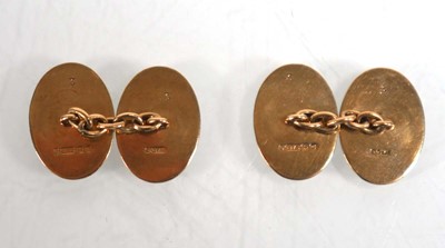 Lot 833 - A pair of 9ct yellow gold oval engine turned...