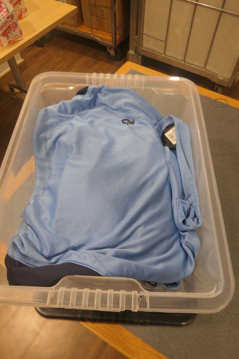 Lot Box containing blue Gryphon hockey tops