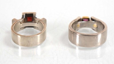 Lot 837 - A modern silver dress ring set pink stone and...