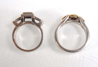 Lot 837 - A modern silver dress ring set pink stone and...