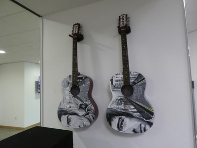 Lot 2195 - Two hand painted guitars by artist Lewyl,...