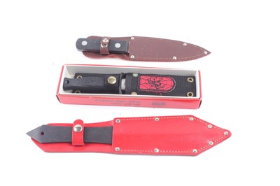Lot 1486 - Two throwing knives with sheaths, and a Black...