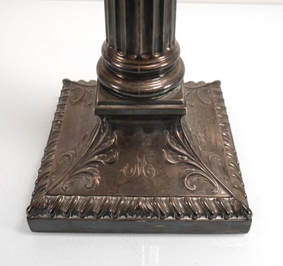 Lot 447 - An Edwardian silver candlestick of Corinthian...