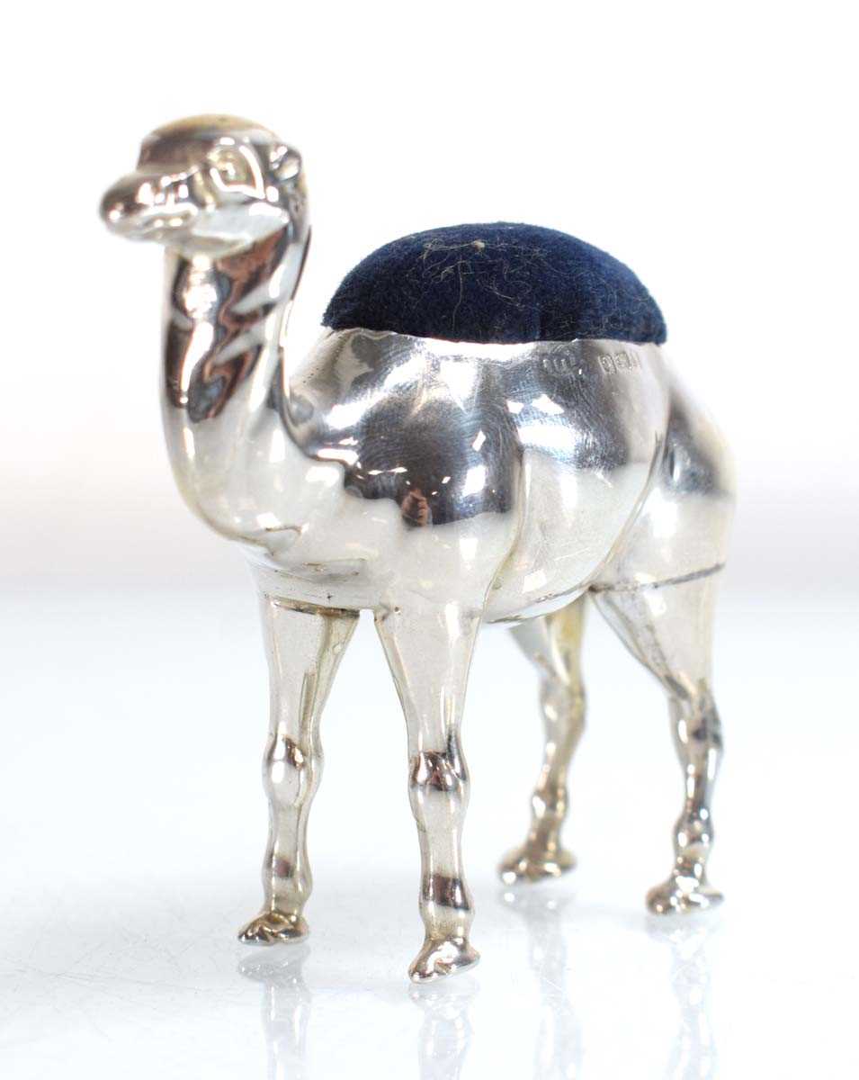 Lot A silver pin cushion modelled as a standing...