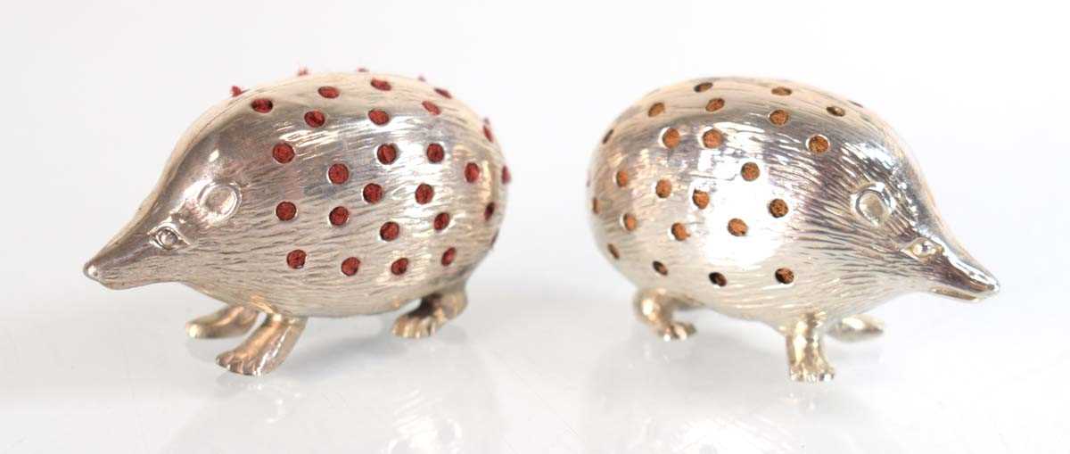 Lot A pair of silver pin cushions, each modelled...