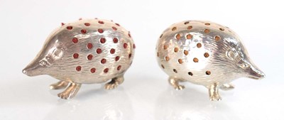 Lot A pair of silver pin cushions, each modelled...