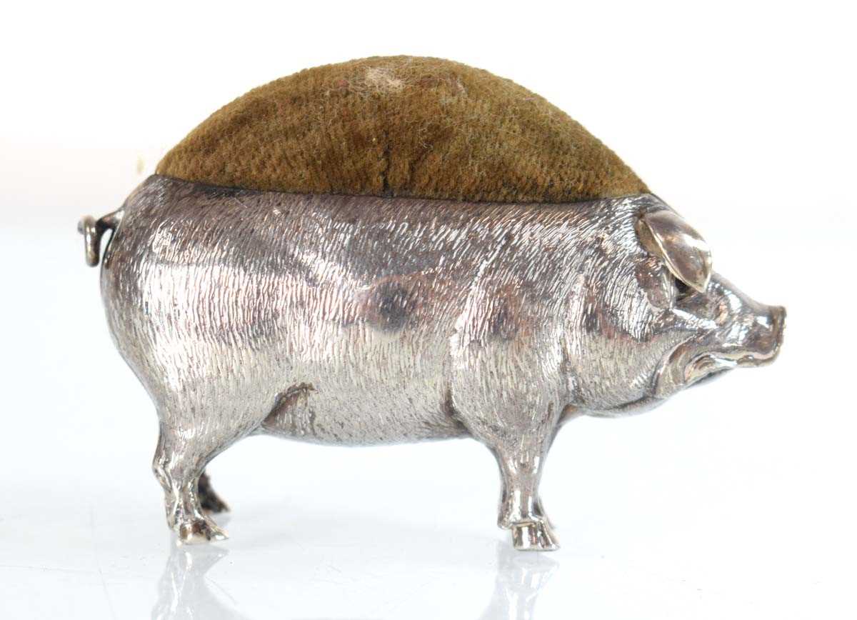 Lot A silver pin cushion modelled as a standing...
