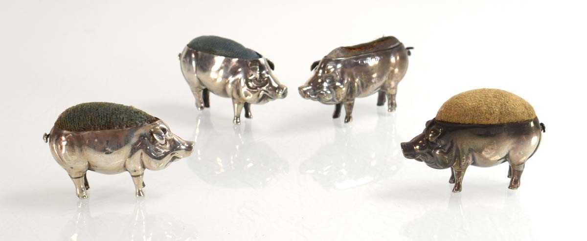 Lot Four silver pin cushions, each modelled as a...