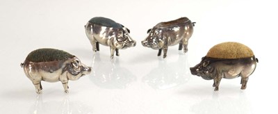 Lot Four silver pin cushions, each modelled as a...