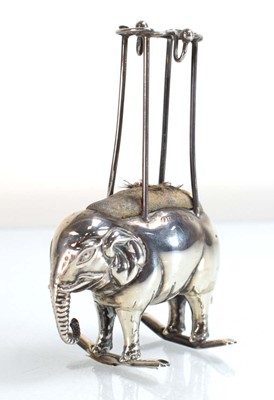 Lot A silver pin hat pin cushion modelled as a...