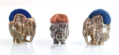 Lot A pair of silver pin cushions, each modelled...