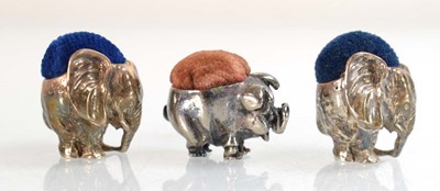 Lot A pair of silver pin cushions, each modelled...