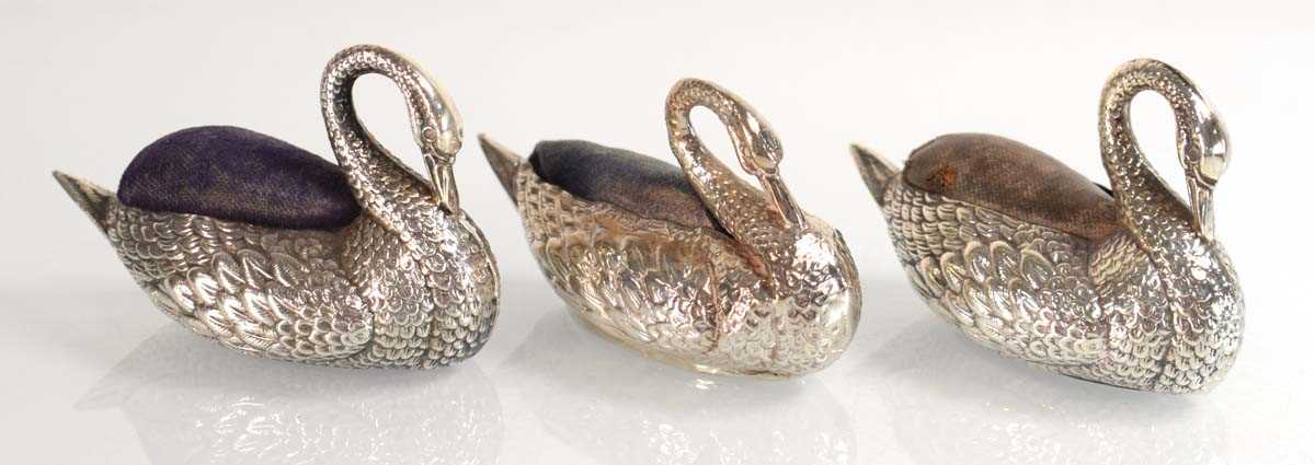 Lot Three silver pin cushions, each modelled as a...