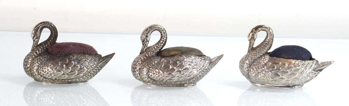 Lot Three silver pin cushions, each modelled as a...