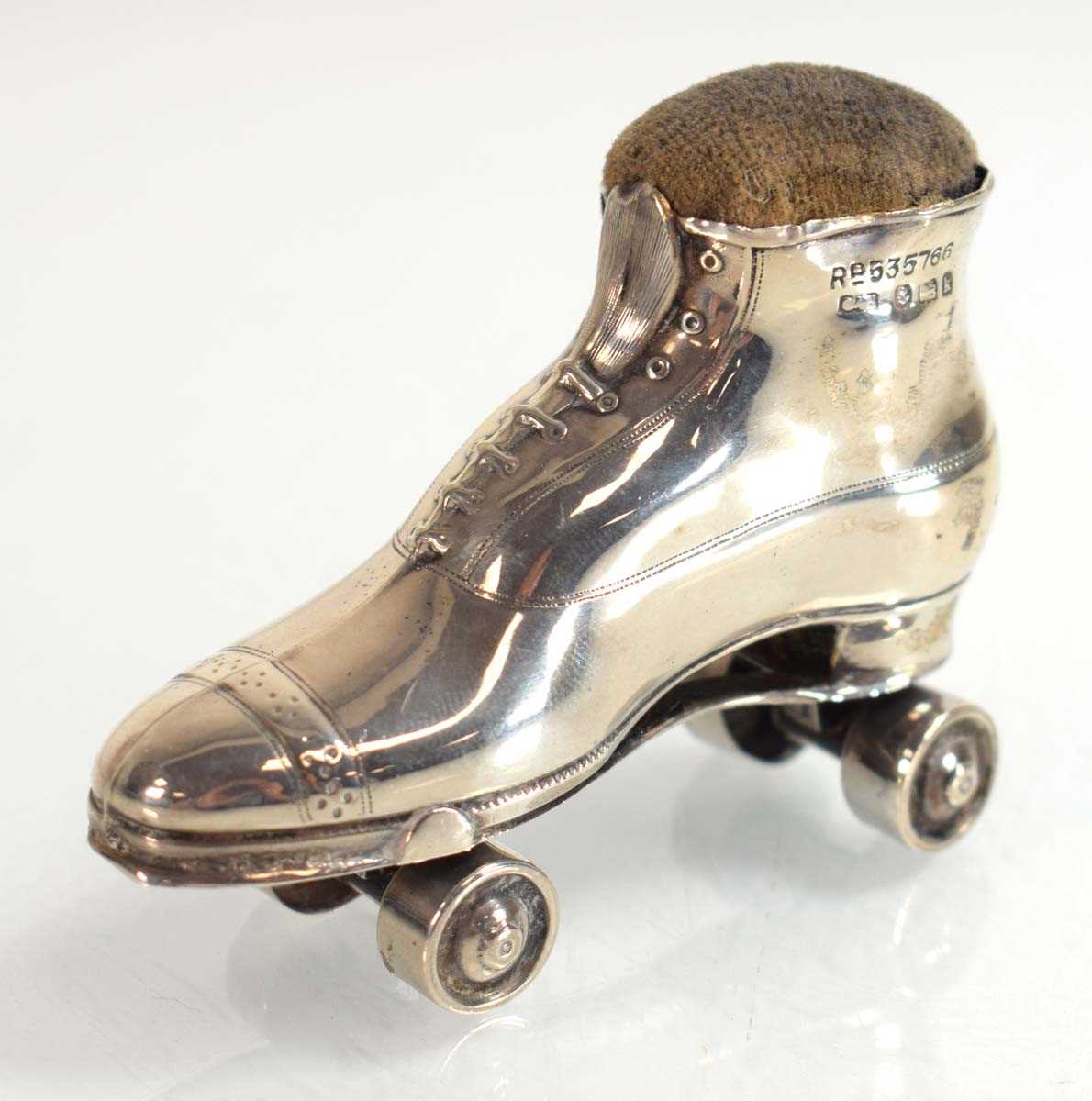 Lot A silver pin cushion modelled as a roller...