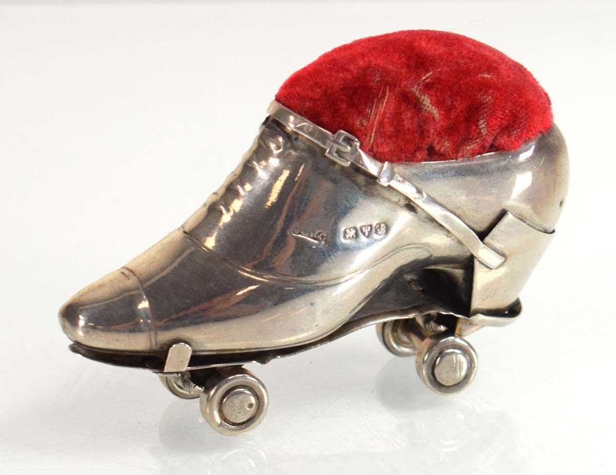Lot A silver pin cushion modelled as a roller...