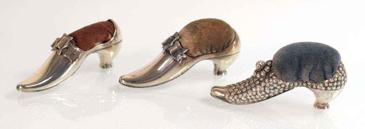 Lot A near pair of silver pin cushions, each...