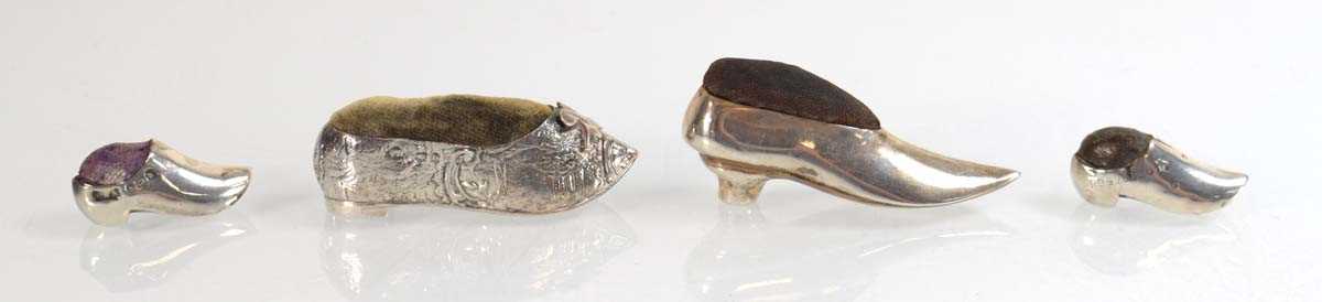 Lot A near pair of miniature silver pin cushions,...