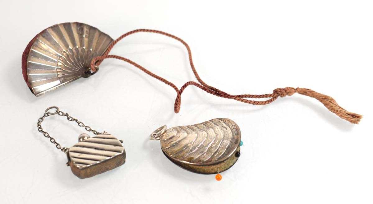 Lot A silver pin cushion modelled as a mussel,...
