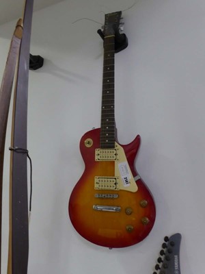 Lot 2141 - An Encore 6-string electric guitar in red & brown