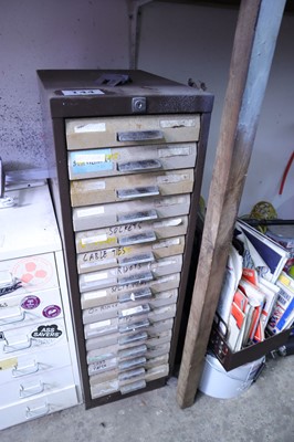 Lot 144 - Brown multidrawer cabinet containing misc....