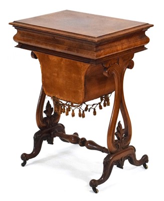 Lot 4 - A Victorian walnut sewing table, the lid...