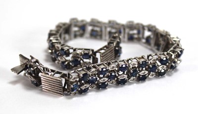 Lot 501 - A white metal articulated link bracelet set...