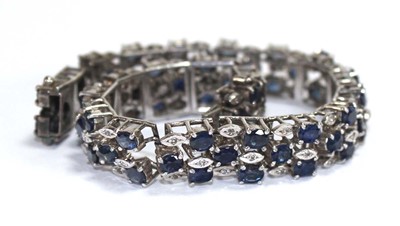 Lot 501 - A white metal articulated link bracelet set...