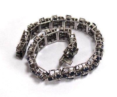 Lot 501 - A white metal articulated link bracelet set...