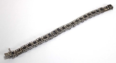 Lot 501 - A white metal articulated link bracelet set...